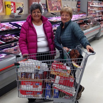 Louisa Alexie and Marj Lubbers purchase groceries for the local food bank in Peace River