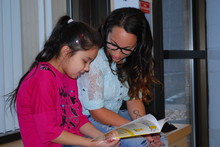 Cenovus Energy employee reading with a Conklin Community School student!