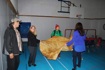 Lorna Rosen, Deputy Minister of Education holding onto a tanned moose hide. In September, Little Buffalo students became familiar with the moose hide tanning process