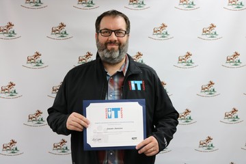 Network Administrator Jason Juneau with his 'Making IT Happen Award'!